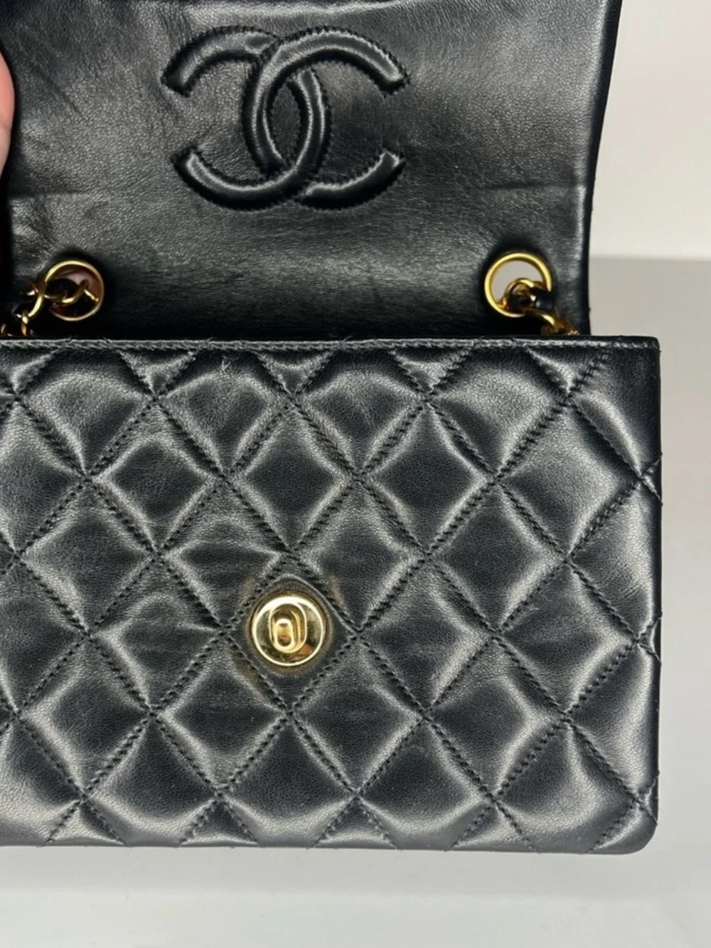 CHANEL Black Quilted Leather Mini Flap Bag with Gold Chain